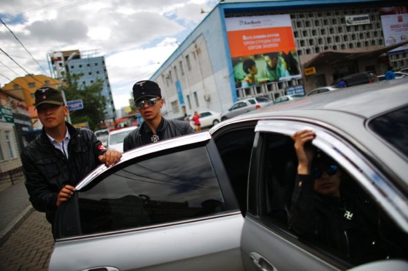 Members of the Mongolian neo-Nazi group Tsagaan Khass leave their headquarters in Ulan Bator